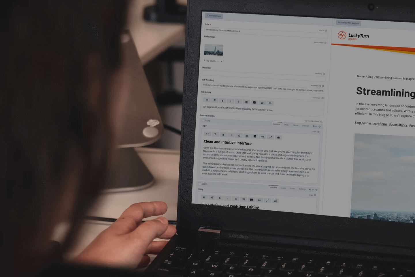 Someone working on a laptop with a CMS on the screen